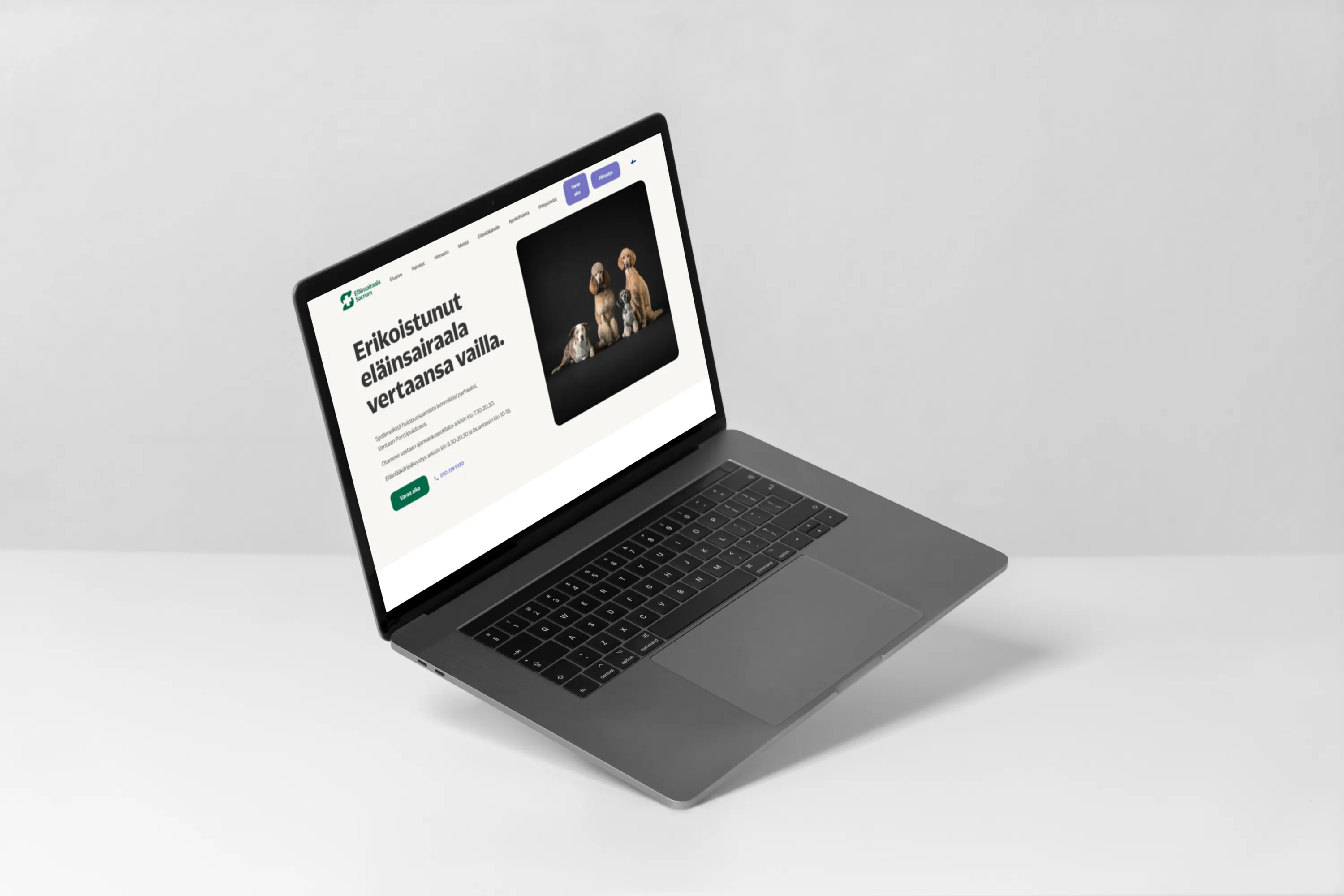 A laptop displays a veterinary hospital website with dogs on the screen, set against a bright, neutral background with soft lighting.